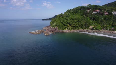 aerial view around a rocky bay at barra do sahy, in sunny costa verde, brazil - circling, drone shot