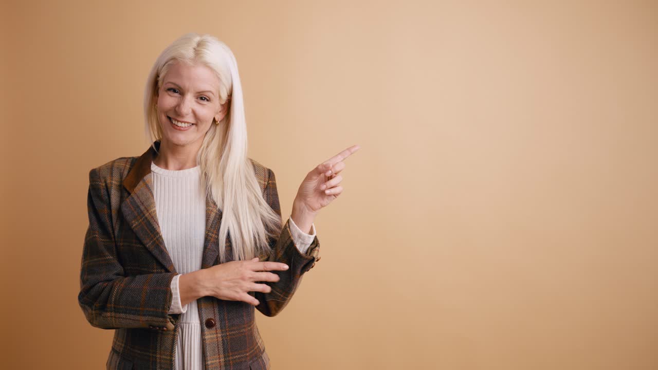 Smiling Blonde Woman Pointing Fingers to the Side