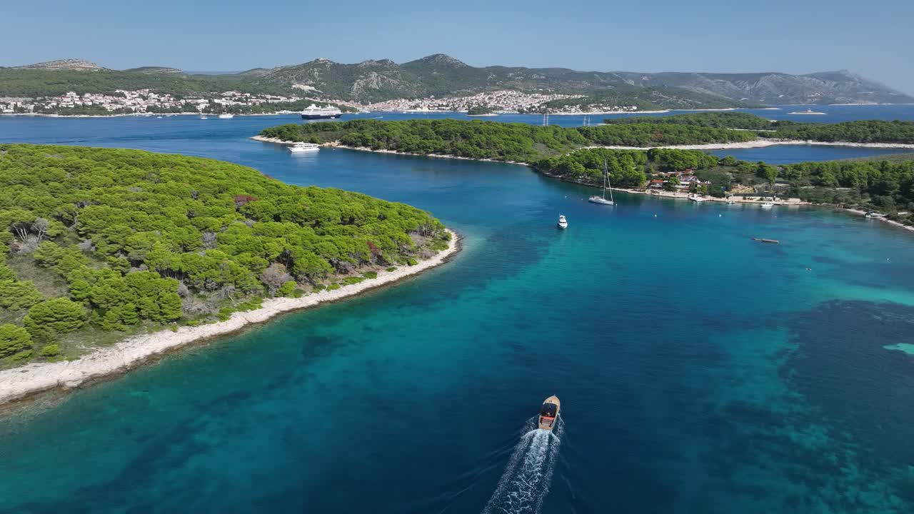 Sailboats And Yacht Cruising In The Blue Sea Along The Island. - aerial shot