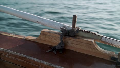 gondola oar lock with an oar tied to it while saling in the sea water