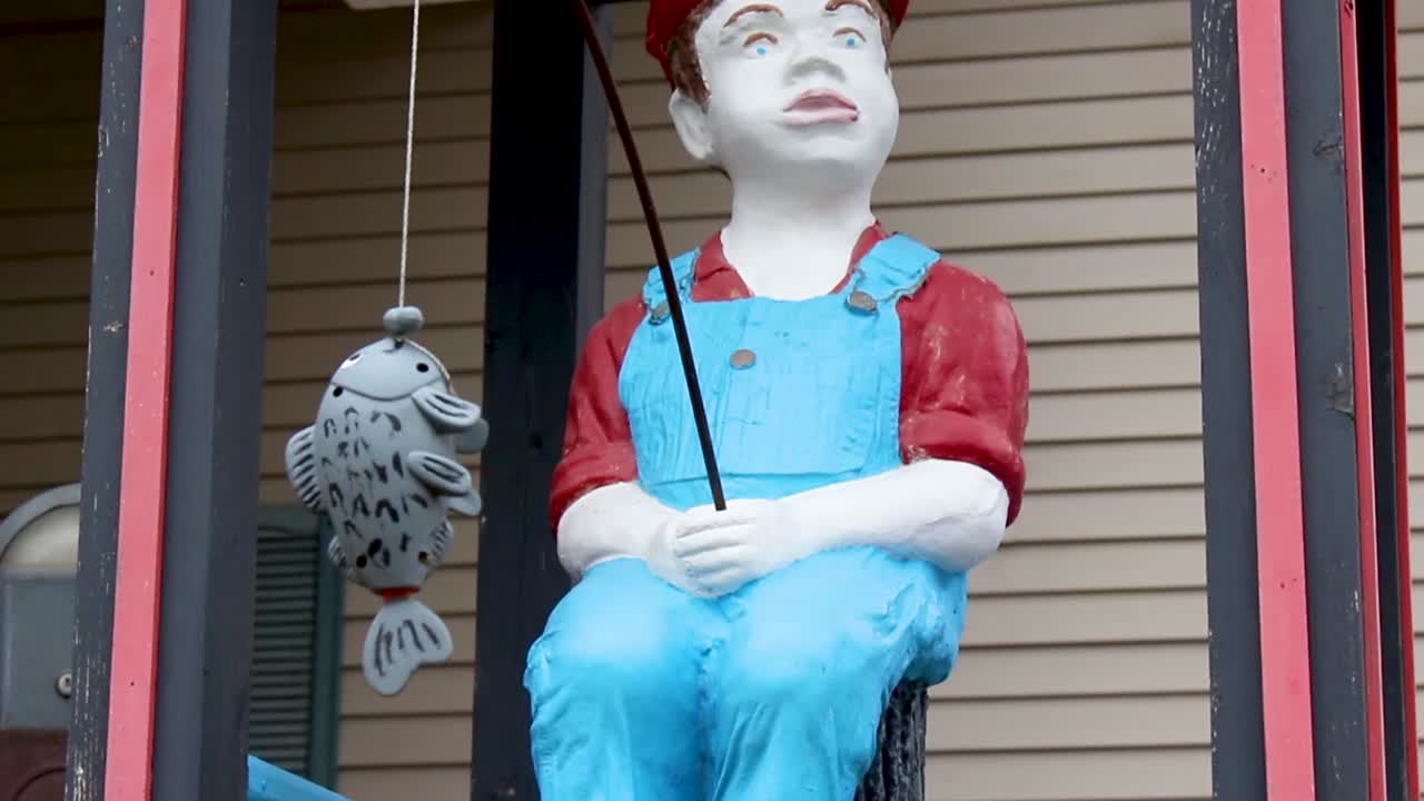 Painted statue of boy fishing 1