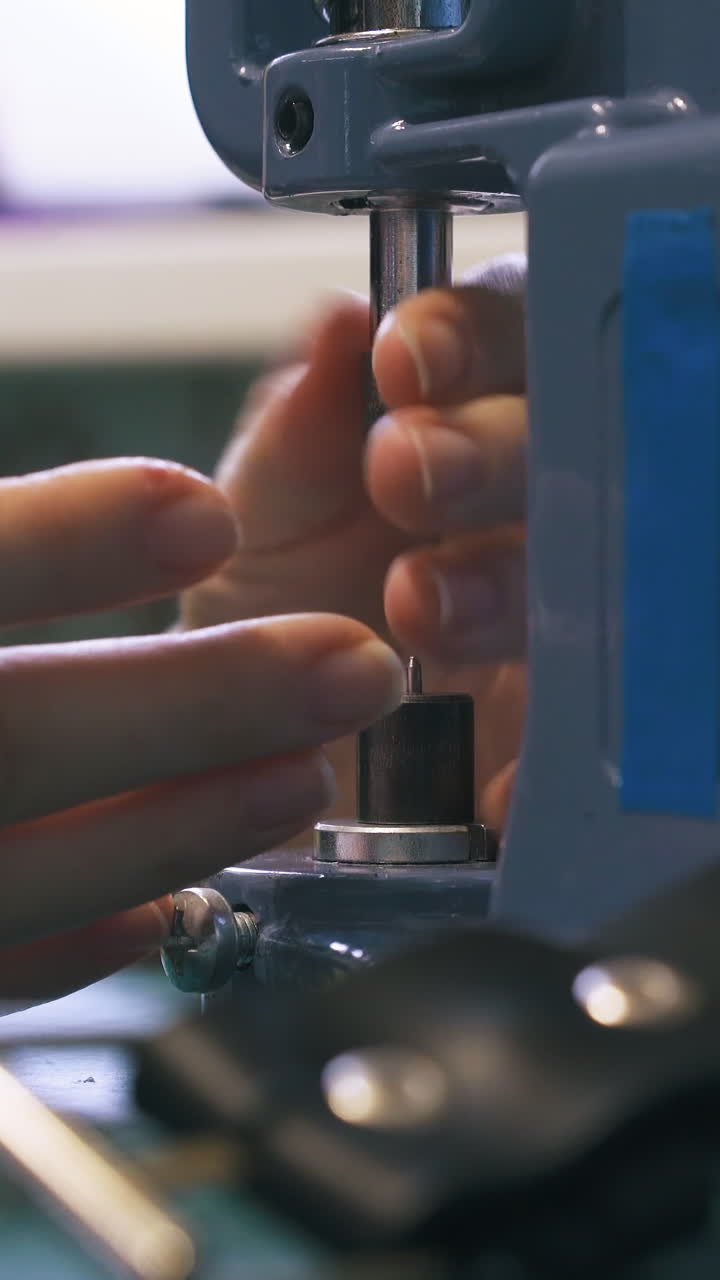 CU: Professional woman designer changes metal nozzles on accessories press machine in workshop close view