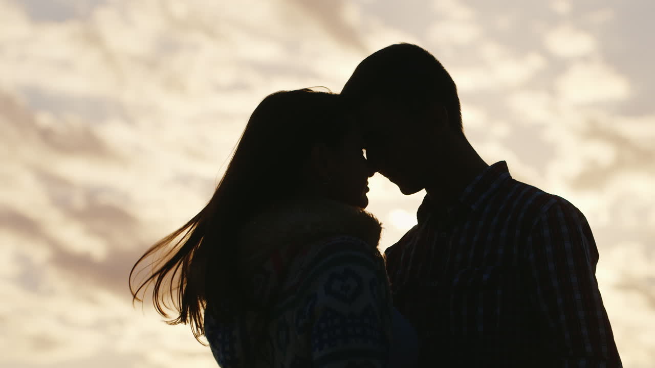 Silhouette Of A Young Couple In Love On The Background Of Sky And Sun  Embrace Touch Their Foreheads Free Stock Video Footage Download Clips Family