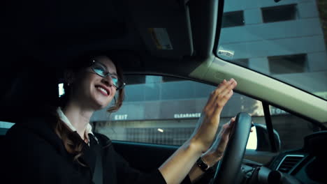 attractive caucasian business woman driving while enjoying listening to music