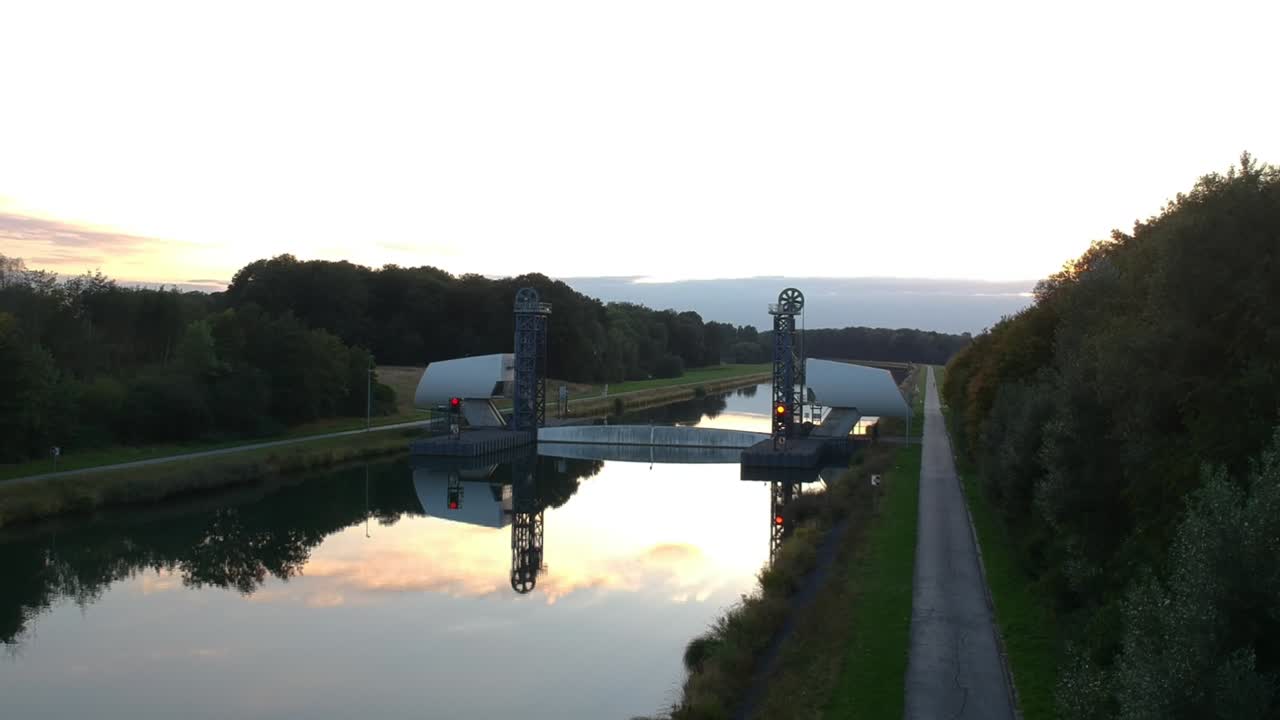 Drone rises over a path next to the dam