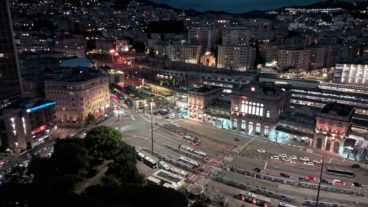 Night aerial view of traffic on street in front of iconic Brignole Station Genoa