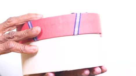 elderly hands holding a gift box