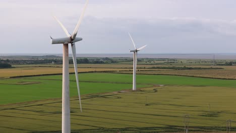 wind turbines amidst green fields landscape