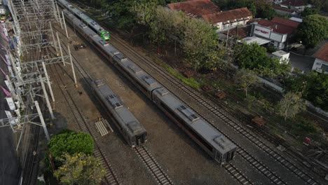 aerial footage, several train carriages parked next to tugu station, yogyakarta