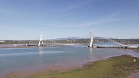 aerial low level panning view of portimao bridge over arade river in portugal