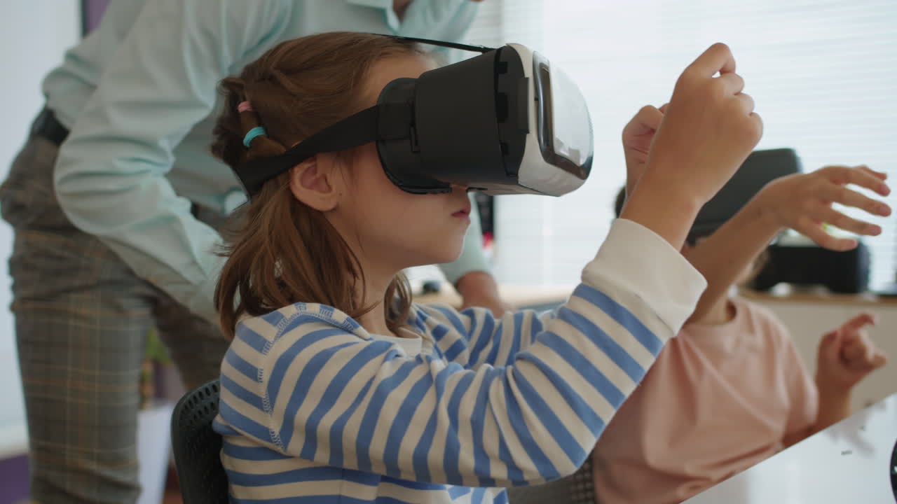 Teacher Helping Kids with VR Glasses during IT Class
