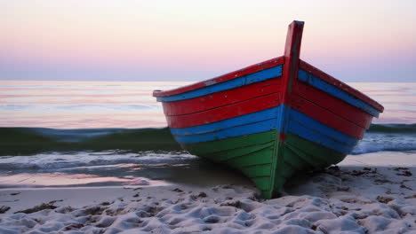colorful wooden boat on the beach at sunrise/sunset