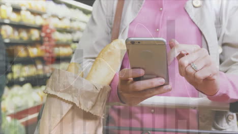 animation of financial data processing and caucasian woman with smartphone shopping in grocery store