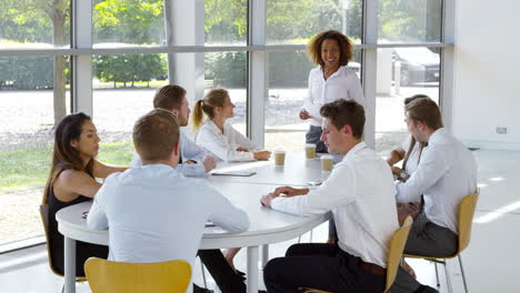 business team having meeting around table in modern office