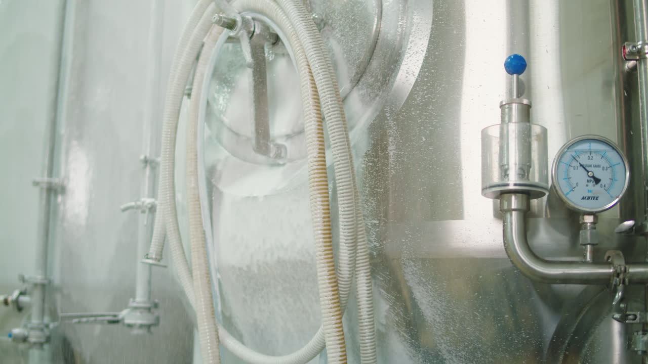 Craft beer production, general cleaning on factory, brewery manufacture. Washing metal vats bottles. Brewing, cooking alcohol