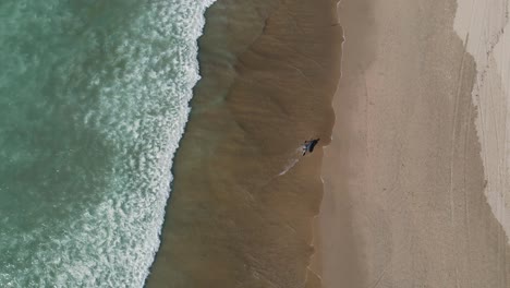 Person-running-on-the-shore-close-to-the-sea