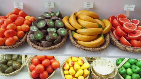 exhibición colorida de frutas artificiales en cestas