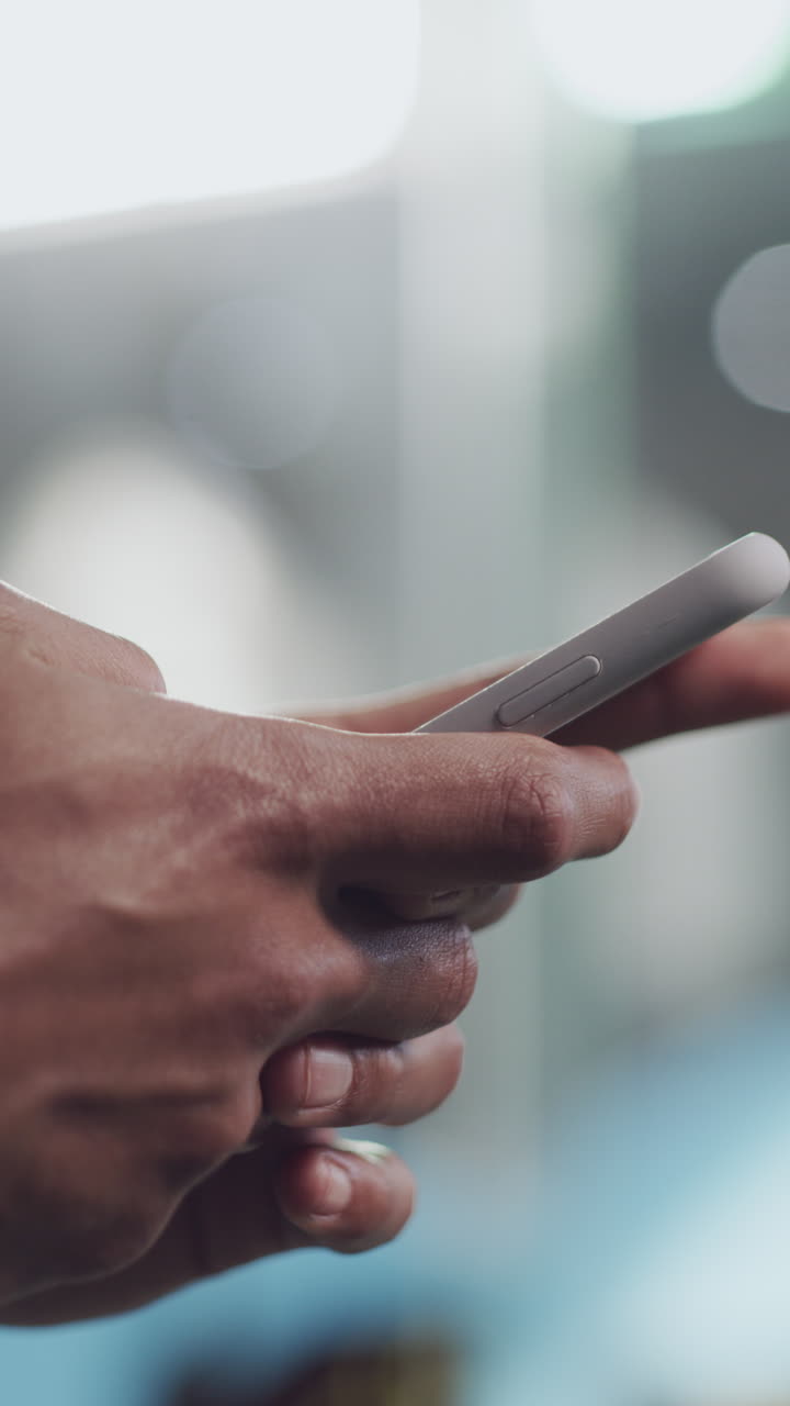 Close-up of Hands Scrolling and Using a Smartphone