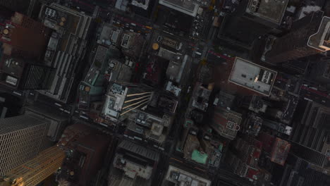 Aerial-birds-eye-overhead-top-down-view-of-traffic-in-streets-in-city.-Fly-above-borough-with-modern-high-rise-apartment-or-office-buildings.-Manhattan,-New-York-City,-USA