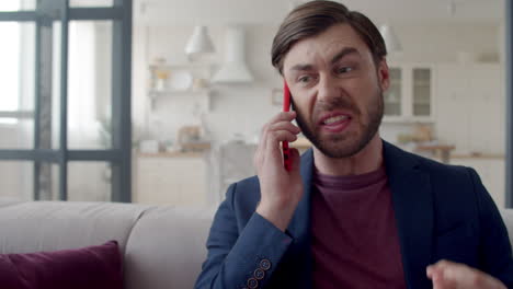 Furious-man-talking-phone-at-remote-office.-Guy-trying-concentrate.