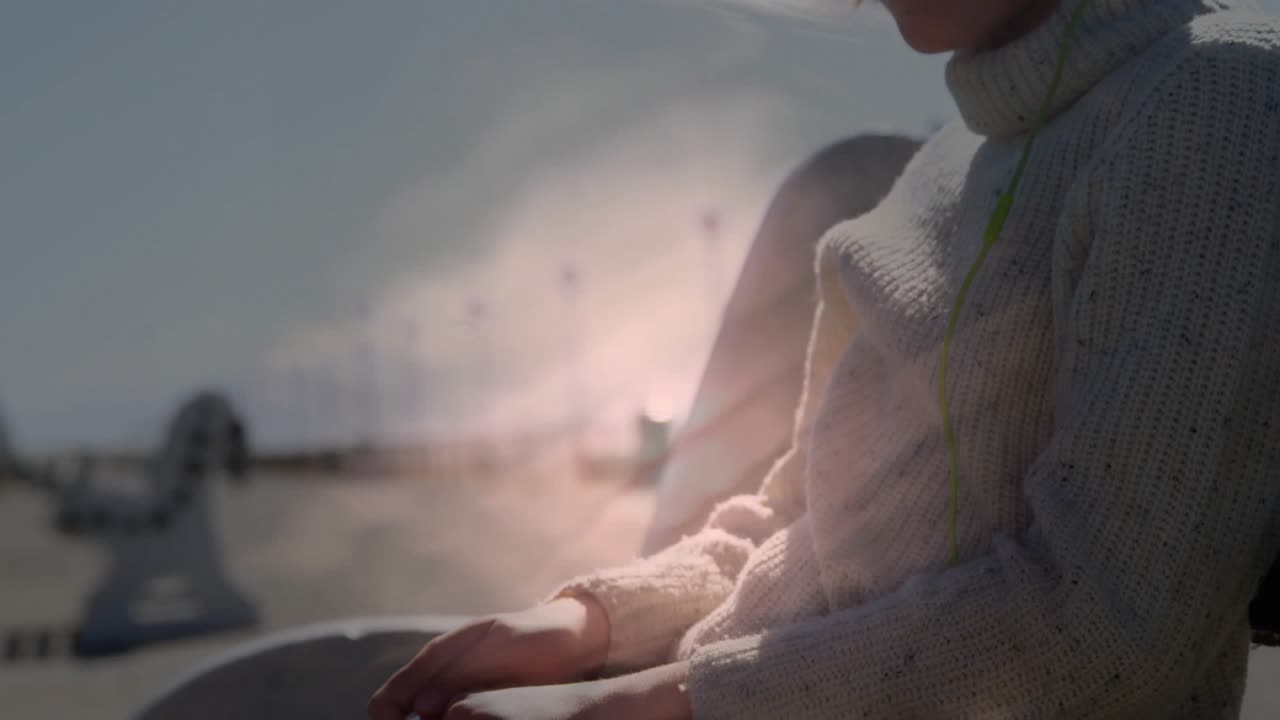 Girl sitting on pier, camera shifting and revealing face with rippling light overlay for marketing