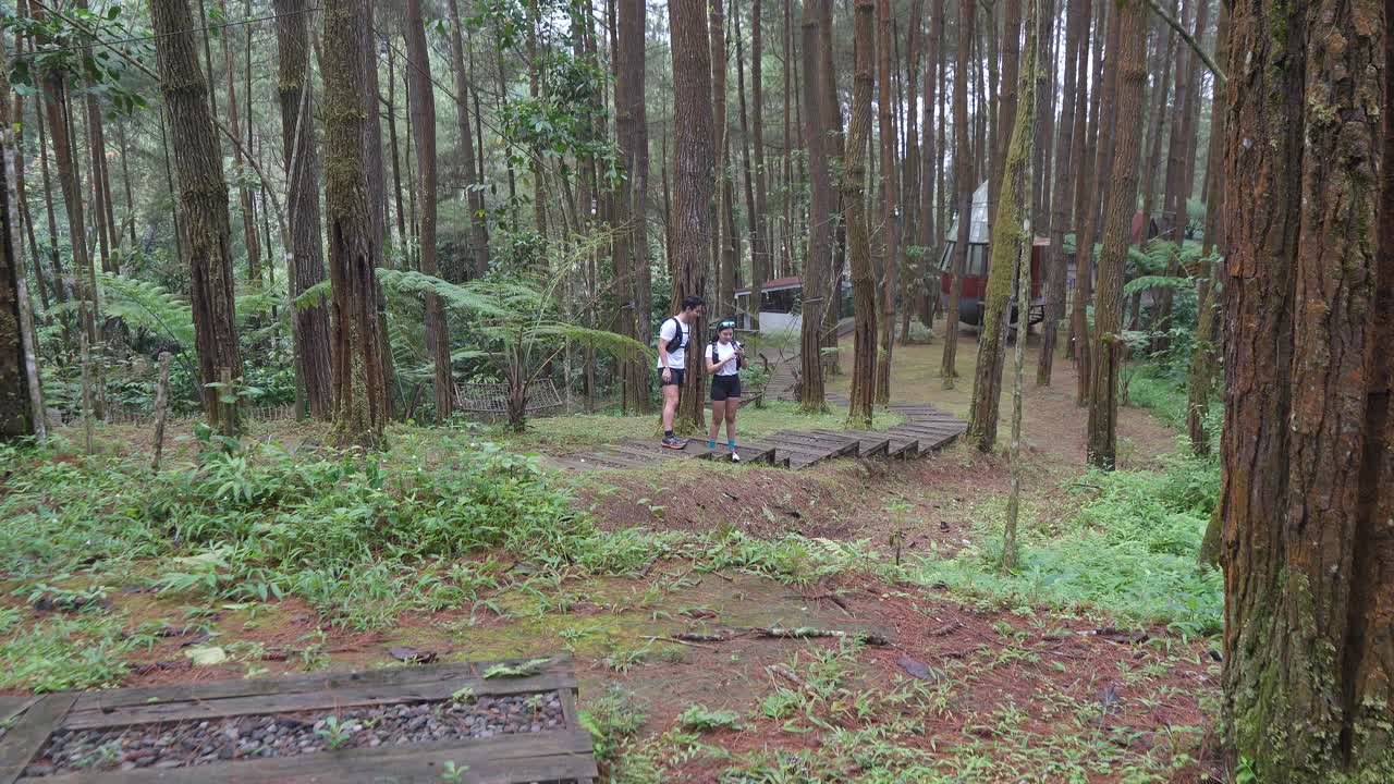 Indonesian young adults using smartphone during trail run in forest