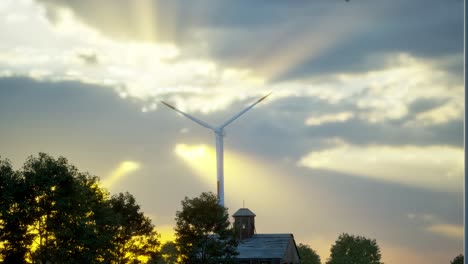 wind turbines standing in sunset. farm with wind turbines. generating clean renewable energy. bright orange sunset. alternative energy