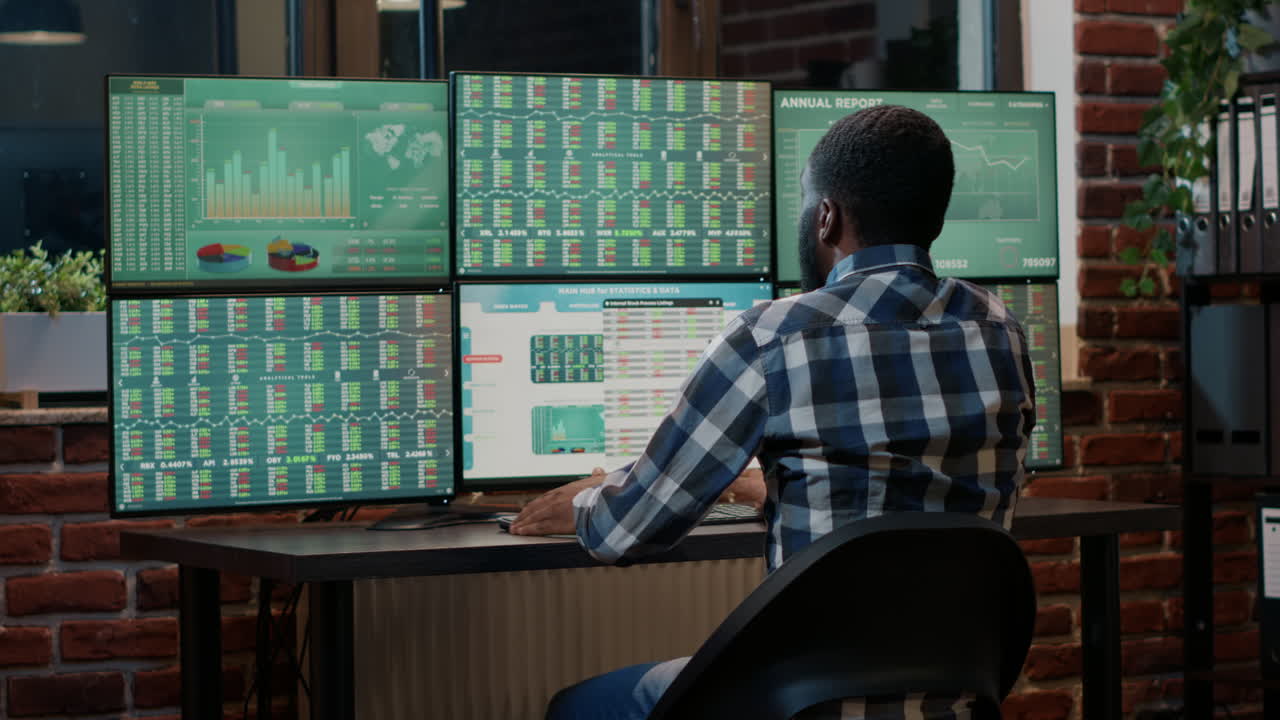 African american man working with stock market charts