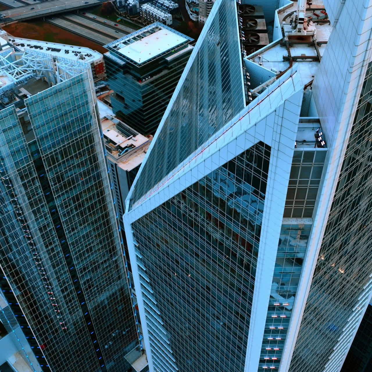 Rising over the pointed top of beautiful skyscrapers with mirror windows. Downtown of Charlotte, North Carolina, USA from air.