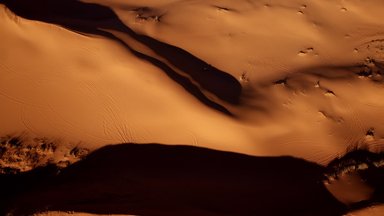 A drone captures the vibrant textures and pink tones of southern Utah’s sand dunes from directly overhead.