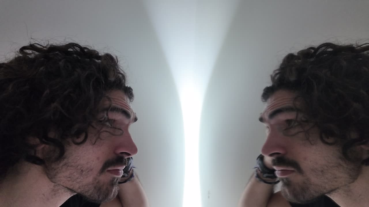 Slow-motion shot of a man examining possible hair loss under soft indoor light