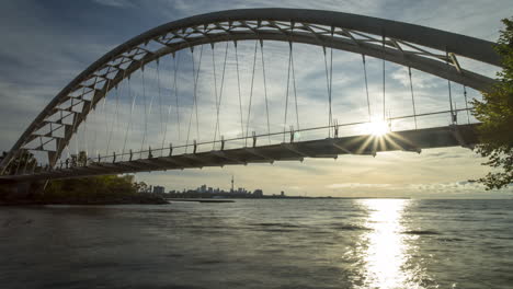 timelapse of the downtown toronto skyline framed under the humber bay bridge