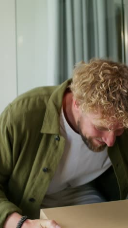 man excitedly opening a gift box