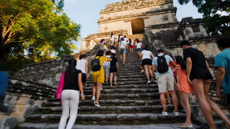 tourists climbing the mayan pyramid
