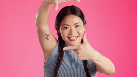 hand, frame and face of asian woman in studio