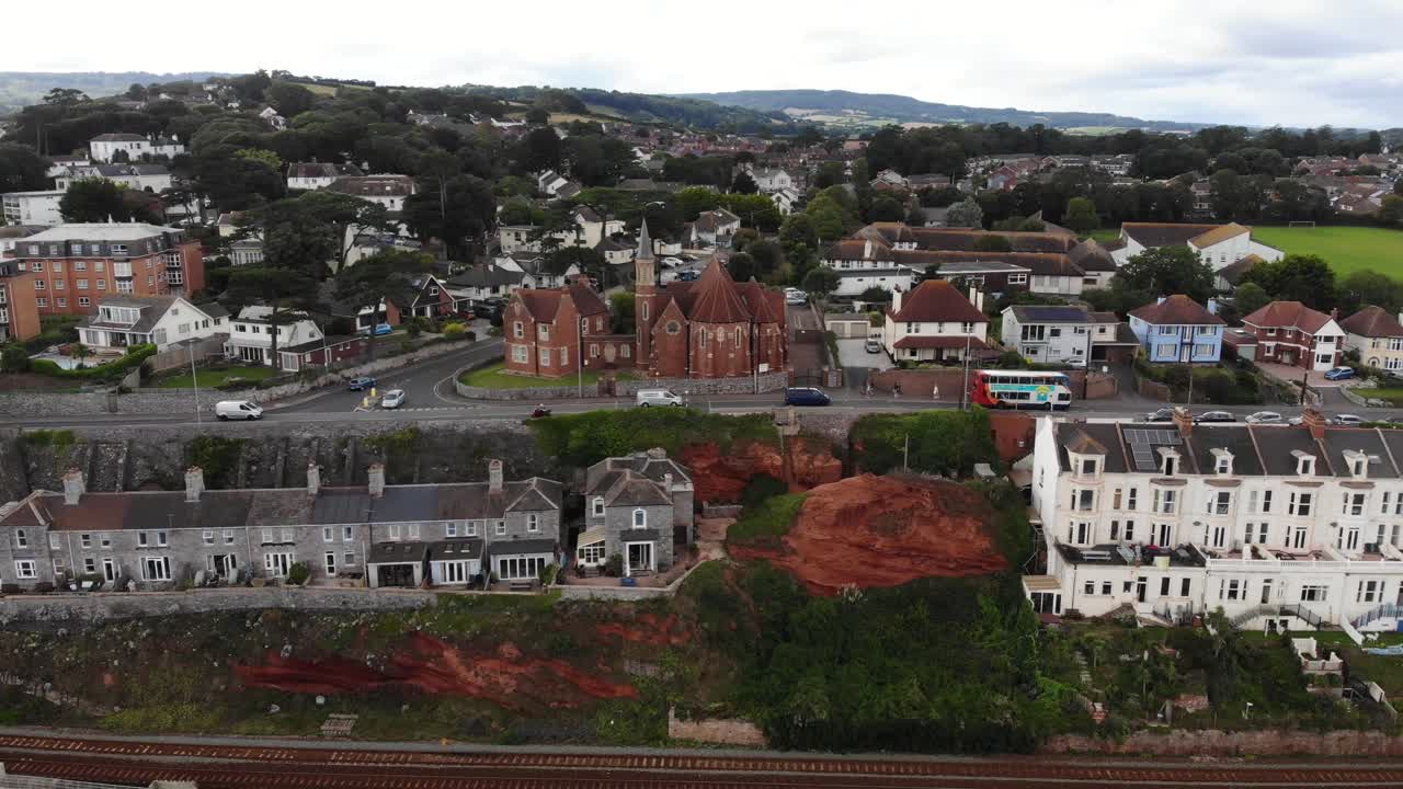 Aerial view of the Dawlish sea wall protecting the railway line and town from coastal erosion in Devon, England. pull back shot