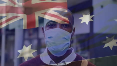 Animation-Der-Flagge-Australiens,-Die-Während-Der-Covid-19-Pandemie-über-Einem-Mann-Mit-Gesichtsmaske-Weht