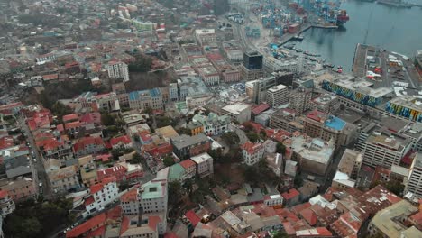 aerial orbit of baburizza palace, yugoslavian walk and el peral funicular in cerro alegre, sea port in the back, valparaiso, chile