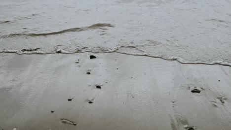 Ocean-waves-on-sandy-beach,-slow-motion