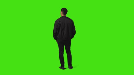 Rear-View-Of-Bored-Or-Fed-Up-Young-Man-Standing-And-Waiting-Against-Green-Screen-Background-3