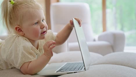 baby girl playing with laptop