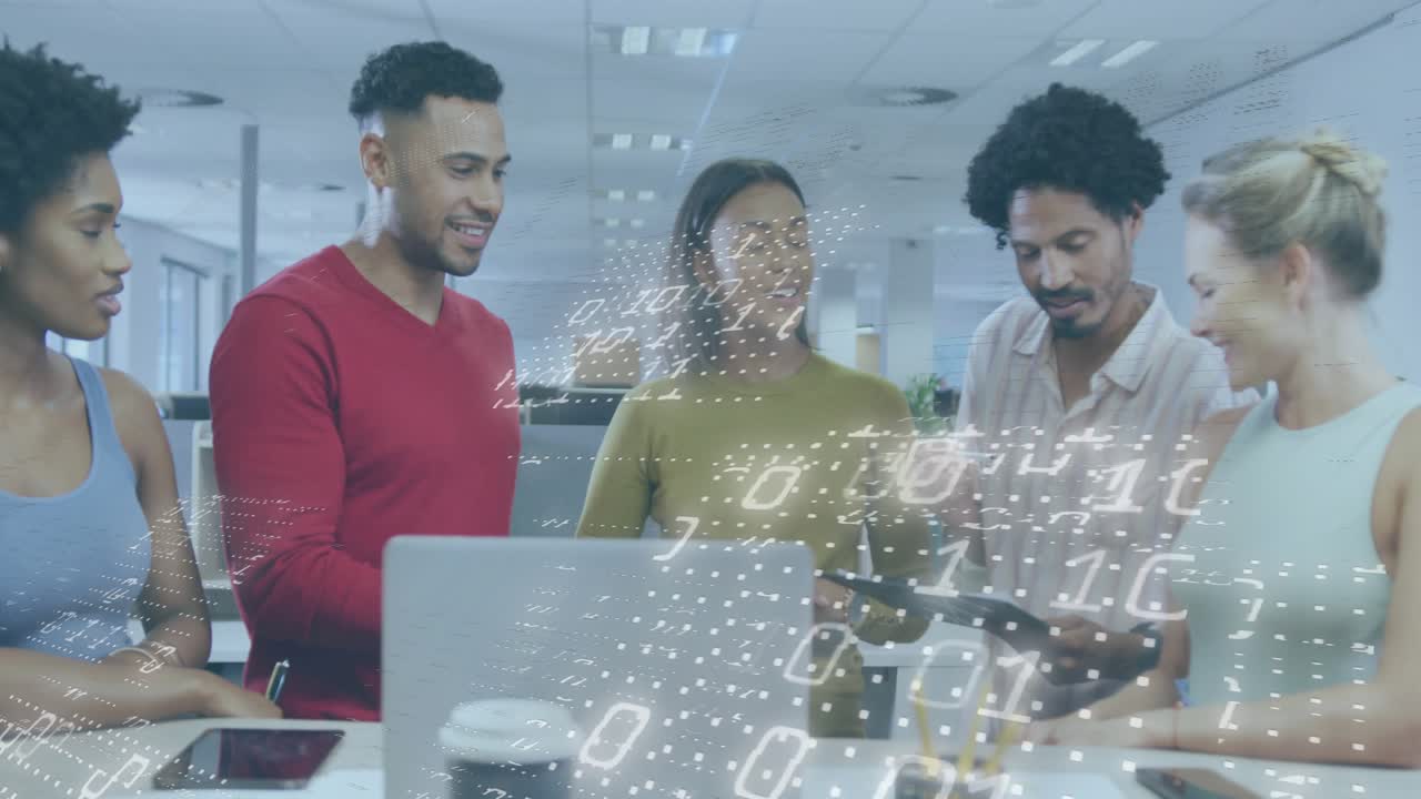 Man in red sweater leaning in, discussing tech with code overlay on laptop or tablet, team laughing
