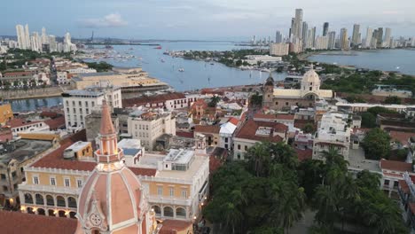 aerial pano of cartagena de indias old town wall with cathedral cusp and modern skyscraper building drone cityscape caribbean coast with port