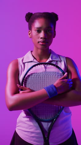video vertical de una jugadora de tenis afroamericana en un relámpago rosa de neón