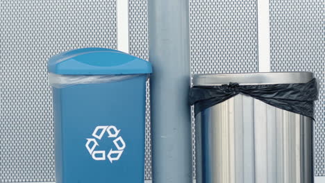 garbage can and recycling bin side by side in building hallway