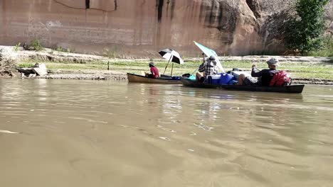 guys paddling to shore on river in utah