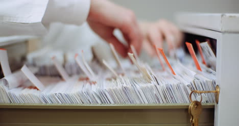 female doctor looks for personal data in the file 6