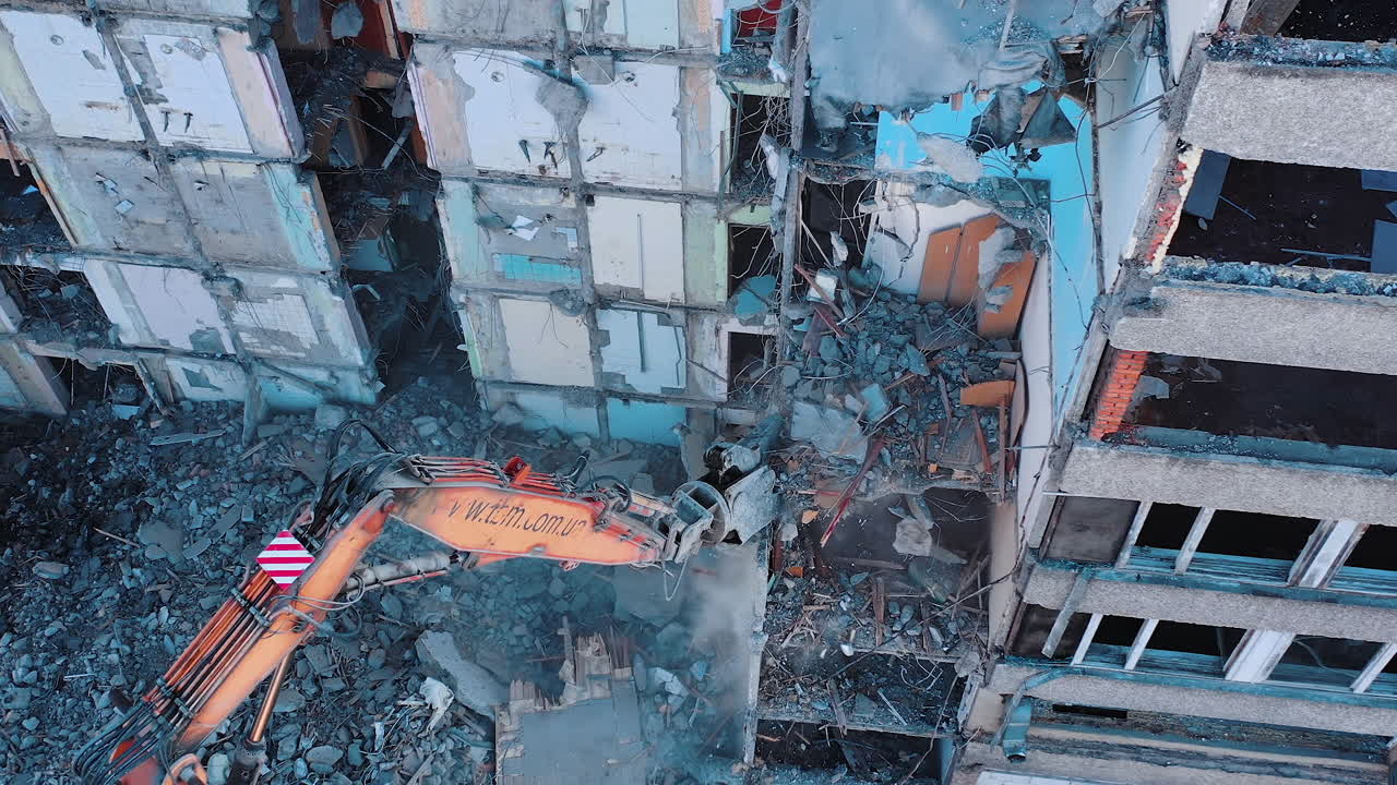 Destroying old building. Destroying large old house with special machine