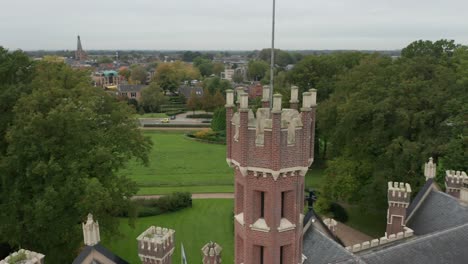 aerial orbit of castle tower with battlements on top of a old castle