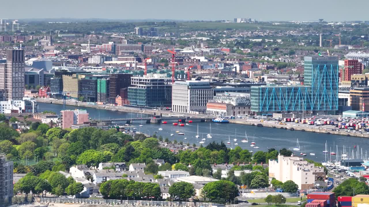 Dublin Docklands and North Wall Quay with commercial building on riverfront. Drone aerial